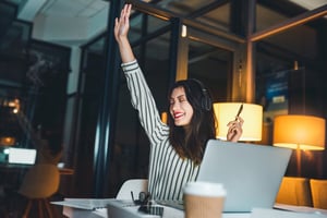 Employee celebrating at desk