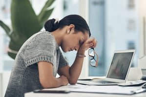 Stressed employee sitting at her desk