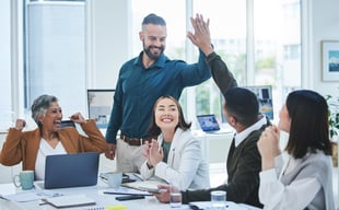 Happy employees high-fiving each other