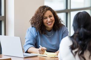 Friendly programs administrator communicating rewards program to employee