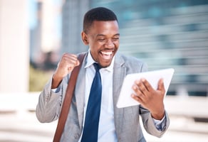 Excited sales employee receiving digital gift card on tablet