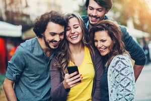 Group of employees smiling and laughing together after receiving employee gift card