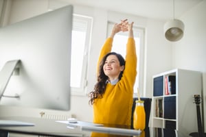 Healthy employee doing stretches at desk