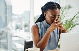 Stressed employee sitting at her desk