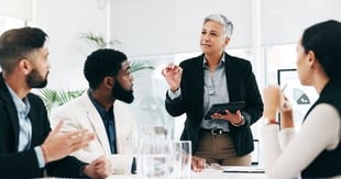 Business manager conducting a meeting with employees