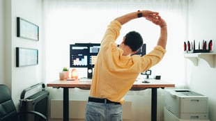 Employee stretching at his standing desk