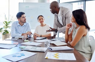 Group of engaged employees working productively together around a conference table