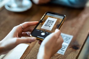 Person scanning a QR code with their mobile phone