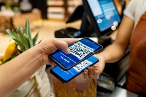 Customer scanning QR code in a shop