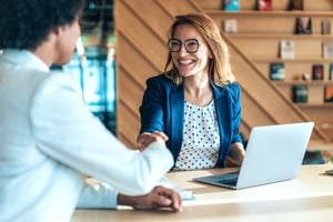 Friendly human resources administrator shaking employee's hand