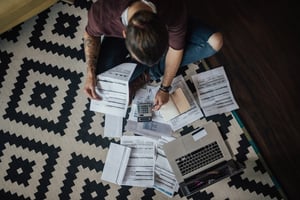 Stressed student calculating bills