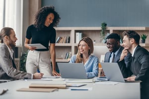 Engaged coworkers socializing at their desks