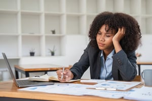 Disengaged employee bored at her desk