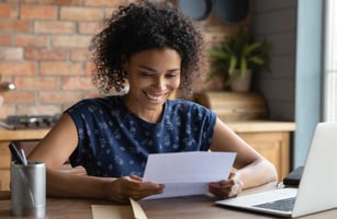 Happy employee reading a recognition letter