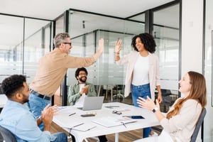 Two peers high-fiving to recognition each other's efforts