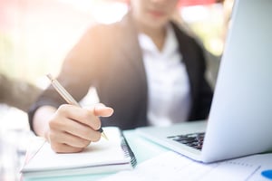 Employee writing in a notebook