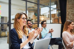 Engaged employees clapping during meeting