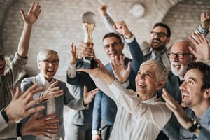 Employees celebrating holding up a trophy