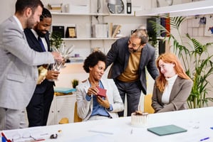 Employee opening gift card surprise from coworkers