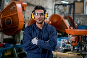 Smiling worker in car manufacturing plant