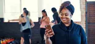 Happy woman receiving health incentive on her mobile phone