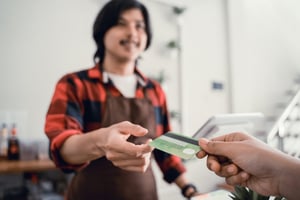 Business owner accepting gift card at checkout