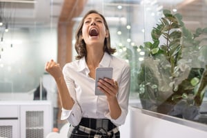 Happy employee receiving an eGift Card instantly on her mobile phone