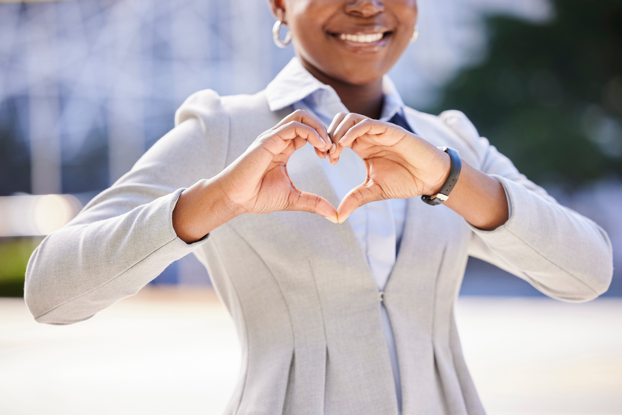 Happy employee holding her hands in the shape of a heart